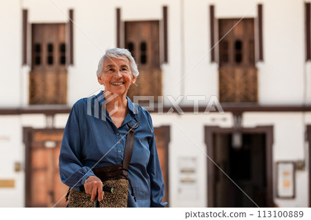 Senior woman tourist at the beautiful heritage town of Salamina in the department of Caldas in Colombia 113100889