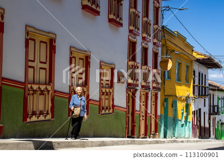 Senior woman tourist at the beautiful heritage town of Salamina in the department of Caldas in Colombia 113100901