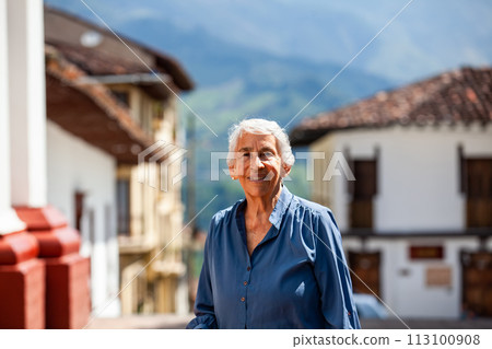 Senior woman tourist at the beautiful heritage town of Salamina in the department of Caldas in Colombia 113100908