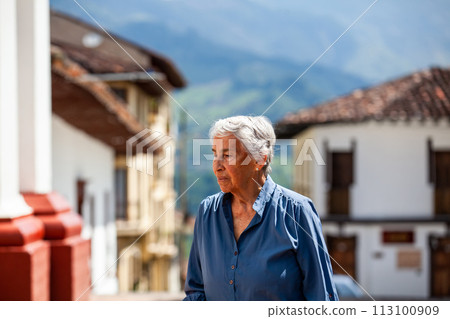 Senior woman tourist at the beautiful heritage town of Salamina in the department of Caldas in Colombia 113100909