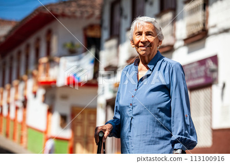 Senior woman tourist at the beautiful heritage town of Salamina in the department of Caldas in Colombia 113100916