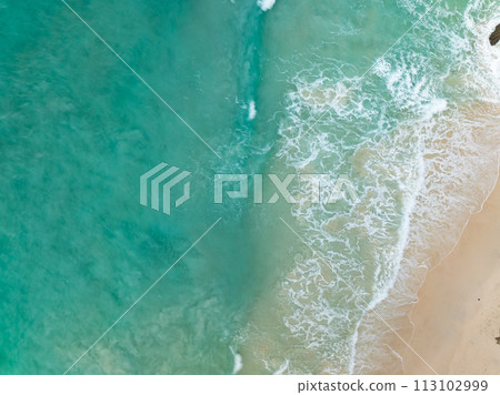 Top view beach with waves crashing on sandy shore,Beautiful waves sea surface in summer seascape background,Amazing beach colorful water background 113102999