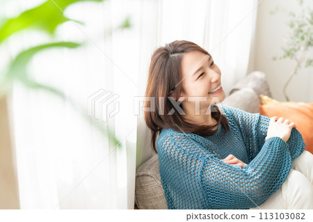 A young woman relaxing in the room A young woman relaxing in the room 113103082