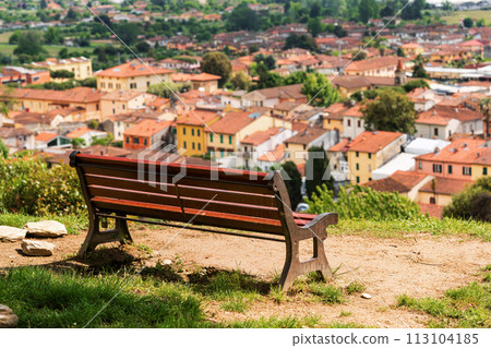 Beautiful view from the mountain on the Italian city, with wooden bench Beautiful view from the mountain on the Italian city, with wooden bench 113104185