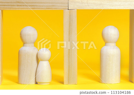 People staying in their flats in apartment house, hospital or prison. Wooden figurines on yellow 113104186