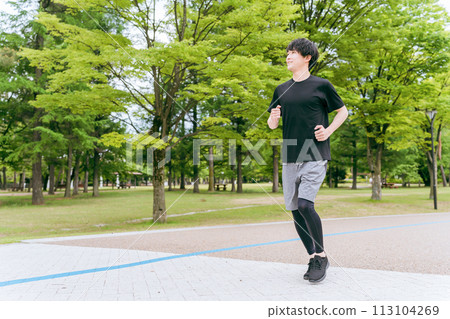 Young man running/jogging/training/doing aerobic exercise in the park Young man running/jogging/training/doing aerobic exercise in the park 113104269