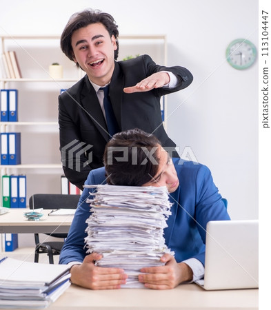 Two male colleagues unhappy with excessive work Two male colleagues unhappy with excessive work 113104447