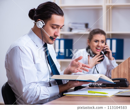 Call center operators working in the office Call center operators working in the office 113104583