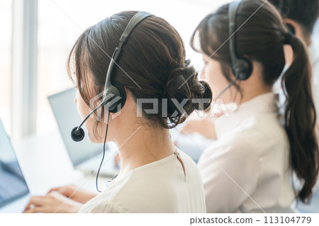 A female operator who answers the phone at a call center 113104779