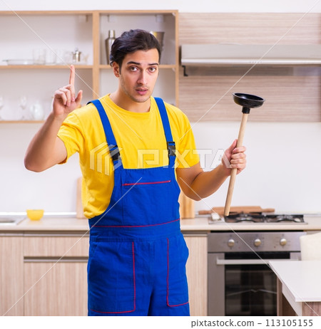 Young male contractor repairing tap at home 113105155
