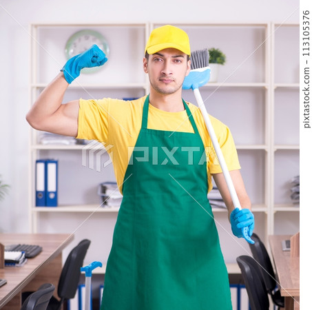 Young male contractor cleaning the office Young male contractor cleaning the office 113105376