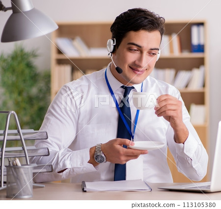 Handsome customer service clerk with headset 113105380
