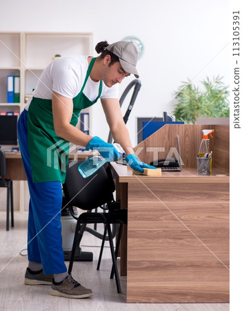 Young handsome contractor cleaning the office Young handsome contractor cleaning the office 113105391