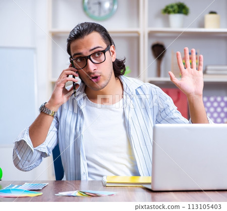 Young male designer working in the office 113105403