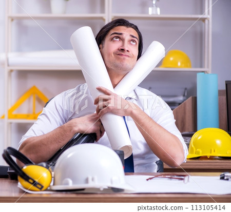 Young male architect working in the office 113105414