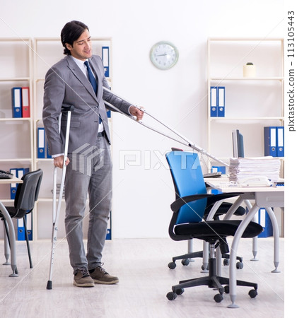 Leg injured male employee working in the office Leg injured male employee working in the office 113105443