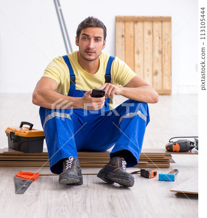 Young male contractor working indoors Young male contractor working indoors 113105444