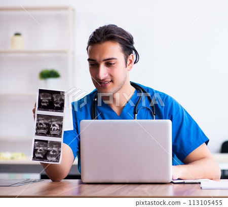 Young male doctor looking at doppler images Young male doctor looking at doppler images 113105455