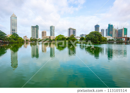 View of Colombo cityscape and skyscrapers reflection on Beira Lake a lake in the center of the city. Colombo is the commercial capital and largest city of Sri Lanka. View of Colombo cityscape and skyscrapers reflection on Beira Lake a lake in the center of the city. Colombo is the commercial capital and largest city of Sri Lanka. 113105514