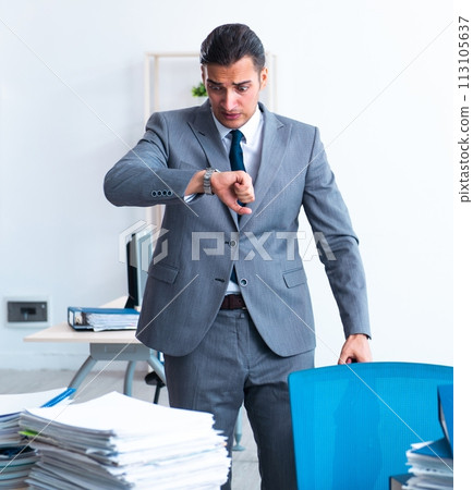 Businessman with heavy paperwork workload 113105637