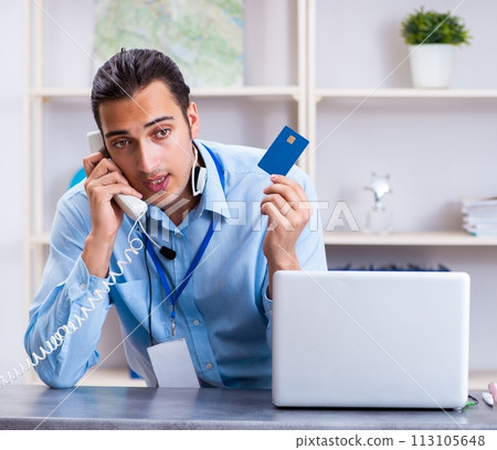 Young male travel agent working in the office Young male travel agent working in the office 113105648