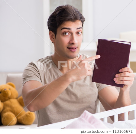 Young dad student preparing for exams and looking after baby Young dad student preparing for exams and looking after baby 113105671