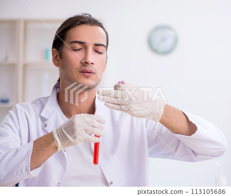 Young male chemist working in the lab 113105686