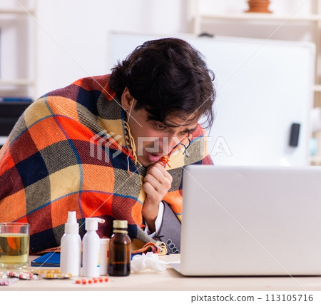 Man with flu working in the office 113105716