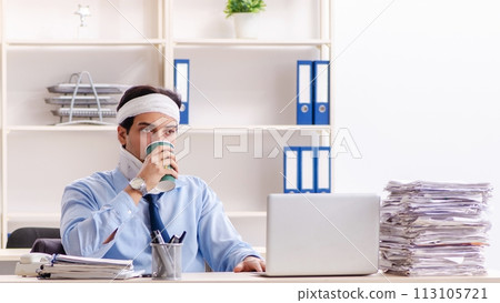 Young injured male employee working in the office Young injured male employee working in the office 113105721