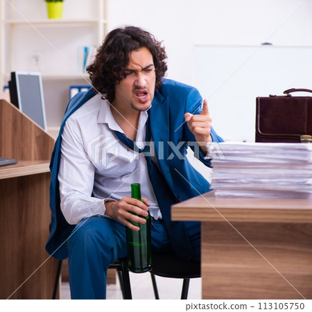 Young drunk employee in the office Young drunk employee in the office 113105750