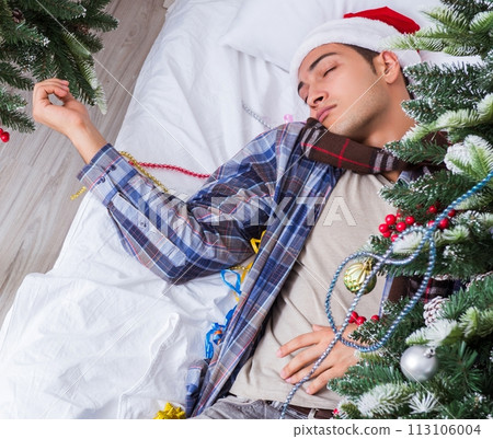Man suffering hangover after christmas party Man suffering hangover after christmas party 113106004