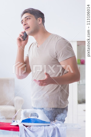 The inattentive husband burning clothing while ironing 113106014