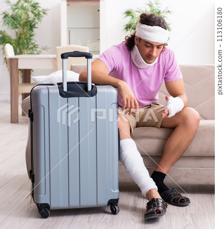 Young injured man preparing for the trip Young injured man preparing for the trip 113106180