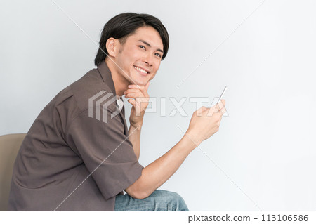 使用智慧型手機的亞洲年輕男子(網路購物、擔憂、考慮、搜尋、研究) 使用智慧型手機的亞洲年輕男子(網路購物、擔憂、考慮、搜尋、研究) 113106586