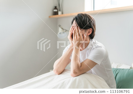 A man feeling depressed on the bed (frustration, regret, suffering, failure, stress, regret, confession, eye strain) A man feeling depressed on the bed (frustration, regret, suffering, failure, stress, regret, confession, eye strain) 113106791