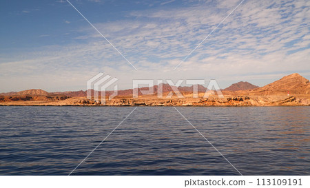 The coast of the Red Sea. Against the background of the Sinai Mountains 113109191