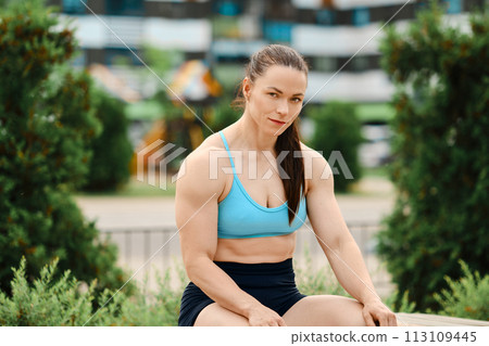 Athletic muscular woman outdoors Athletic muscular woman outdoors 113109445