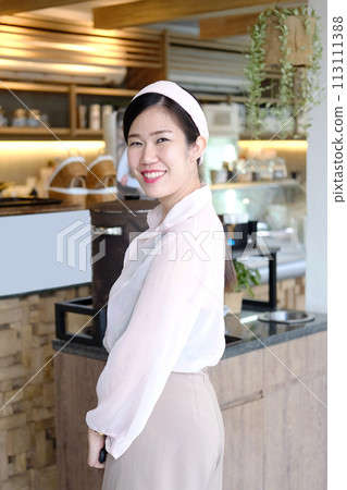 Beautiful Portrait Asian businesswoman is smiling and relaxing in cafe and coffee shop Beautiful Portrait Asian businesswoman is smiling and relaxing in cafe and coffee shop 113111388