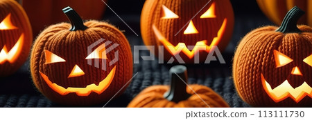 A knitted pumpkins with glowing smiles creates a playful Halloween scene A knitted pumpkins with glowing smiles creates a playful Halloween scene 113111730