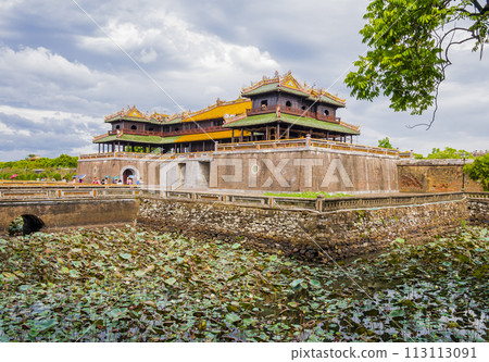 Tourists sightseeing the imperial citadel of Hue entering through the meridian gate, Vietnam Tourists sightseeing the imperial citadel of Hue entering through the meridian gate, Vietnam 113113091