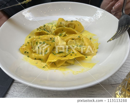 Ravioli with cheese and herbs on a white plate at Valetta restaurant, Malta 113113288