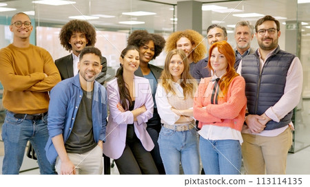 Group of colleagues smiling at camera in a coworking space Group of colleagues smiling at camera in a coworking space 113114135