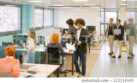 Coworkers arriving at the office and sitting on desk Coworkers arriving at the office and sitting on desk 113114145