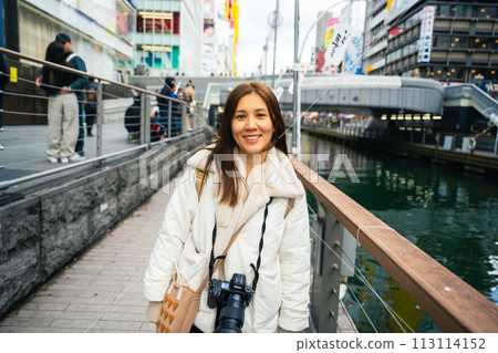 Osaka, Japan, Asia Female Tourist in Dotonbori or Dotonbori Night Shopping District Gourmet Stroll, Dotonbori is Japan 113114152