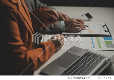 Business team working with new startup project plan and discussion information for financial strategy with laptop and digital tablet in a modern business lounge. 113114764