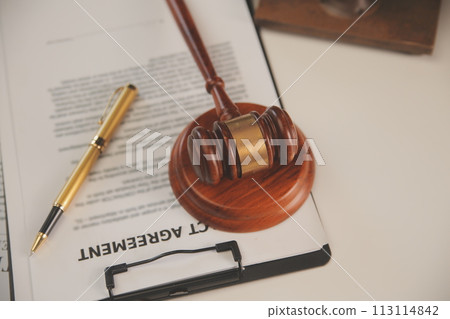 image of judge's hammer, scales lady of justice, law book, laptop computer and contract documents with pen concept of law and justice. image of judge's hammer, scales lady of justice, law book, laptop computer and contract documents with pen concept of law and justice. 113114842