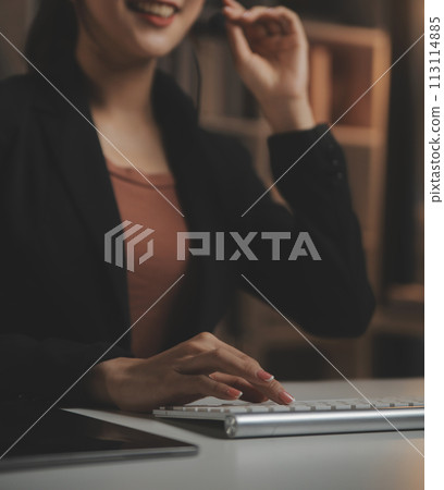 Young woman working in call centre, surrounded by colleagues Young woman working in call centre, surrounded by colleagues 113114885