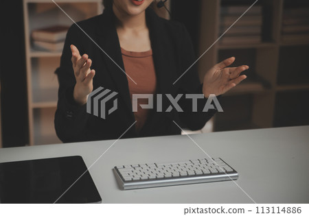 Young woman working in call centre, surrounded by colleagues Young woman working in call centre, surrounded by colleagues 113114886