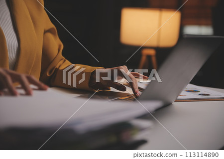 Business woman using calculator for do math finance on wooden desk in office and business working background, tax, accounting, statistics and analytic research concept 113114890