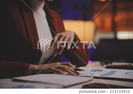 Business woman using calculator for do math finance on wooden desk in office and business working background, tax, accounting, statistics and analytic research concept 113114910